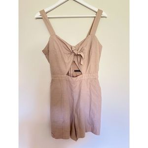Short romper with pockets. Slight cut out above the belly button.